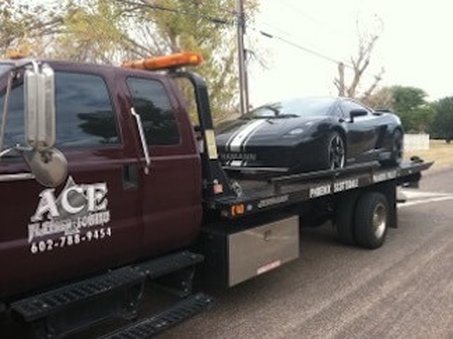 Nice exotic car loaded on back of tow truck